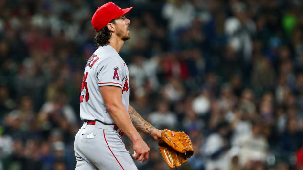 Angels starting pitcher Michael Lorenzen (25) reacts after walking in a run against the Mariners during the fourth inning.